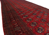 Repeating navy and ivory gul medallions down the length of a fine brick red Bokhara runner.