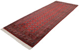 Full perspective of the vintage Bokhara rug runner displaying its orderly rows of gul medallions.