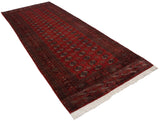 Angled view of the fine Bokhara rug runner showcasing its lustrous brick red pile.