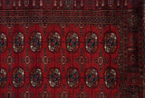 Intricate geometric border and repeating gul medallions on a fine vintage Bokhara rug runner.