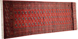 Full length angled view of a vintage Bokhara runner with columns of gul medallions.