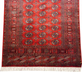 Vintage fine Bokhara runner with repeating gul medallions, complex borders, and a clean ivory fringe.