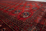 Angled perspective on the dense pile and repeating gul medallions of a fine Bokhara rug.
