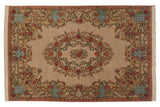 Vintage Bulgarian Aubusson carpet with a rose bouquet medallion, scrolling vines, and a dusty rose border.