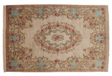 Oblong cameo medallion and rose bouquets on the ivory field of a vintage Bulgarian Aubusson carpet.