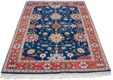 Large-scale palmettes and sprawling vinery cover the sapphire blue field of this vintage Indian rug.