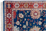 Intact side cord selvage, ivory fringe, and red geometric border on a hand-knotted vintage rug.