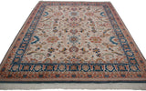 Corner view of Sultanabad design carpet, highlighting denim blue palmette border and ivory fringe.