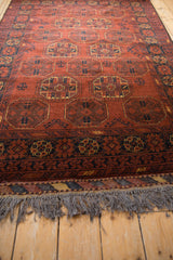 Low-angle view across the full, plush pile of a vintage Afghani Bokhara design rug.