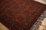 Charcoal border with saffron yellow motifs and grey fringe on a vintage Bokhara rug.