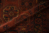 Detail of repeating gul medallions and plush wool pile on a vintage Afghani Bokhara rug.