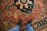 Elaborate copper vinery and charcoal navy floral blossoms on vintage Serapi carpet.