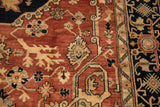 Elaborate terracotta vinery, floral blossoms, geometric charcoal navy border on the vintage Serapi carpet.