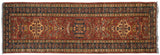 A single column of center medallions on a Pakistani rug with dragon-inspired elements.