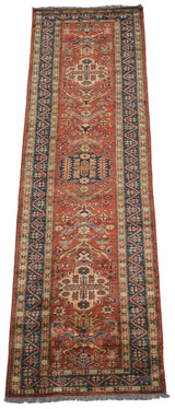 Perspective view down a Caucasian runner with repeating red and blue medallions.