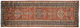 Pakistani Caucasian runner showing its sprawling dragon motifs in cherry red and indigo blue.