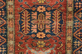 A central medallion with inverted coloration of indigo blue on a cherry red field.