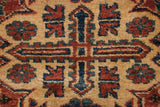 Close-up of hand-knotted dragon motifs in cherry red and indigo blue on a saffron field.