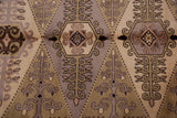 Intricate hand knotted pattern with germinating floral guls in beige, mauve, olive, brown.