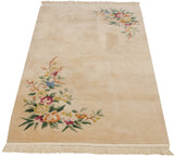 Corner of vintage Japanese Art Deco rug, intricate multicolor floral motif and shadow-embossed vines.