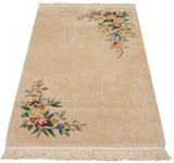 Multicolor floral bouquet, shadow embossed design, and ivory fringe of a Japanese Art Deco rug.
