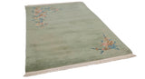 Hand-knotted Japanese Art Deco rug with plush ocean green field, sprawling blush and blue floral motifs.