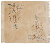 Plush beige pile and ornate pastel foliage on a vintage Japanese Art Deco rug corner.