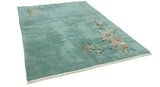 Sprawling blush, ivory, brown floral vines on plush ocean blue Art Deco rug.