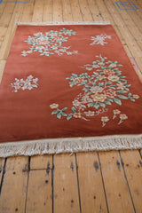 Hand-knotted pile of Art Deco floral spray in celadon, ivory, and mauve tones.
