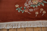 Clean ivory fringe bordering plush copper Art Deco pile with floral motifs.