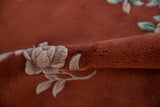 Full copper pile and raised ivory floral motif on a vintage Art Deco rug.