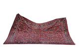 A vintage Mahal carpet draped to show its full pile and rich, gem-like tones.