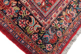 Plush pile on the corner of a vintage Mahal carpet showing gem-like ruby, turquoise, and navy floral motifs.