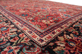 Low-angle view across the lush, full pile of a vintage Mahal carpet's corner and border.
