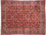Gem-like ruby, turquoise, and sapphire tones in the floral lattice of a vintage Persian Mahal carpet.