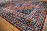 Vintage Indian Bijar rug corner, intricate borders with denim blue, rust, and blush details.