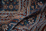Detail of vintage Indian Bijar carpet showing Herati design in denim blue, rust, and sand.