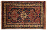Vintage Indian Shiraz rug with three diamond medallions on an indigo field filled with stylized birds and animals.