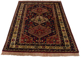 A vintage Indian Shiraz design rug with bold medallions shown from an angled perspective.