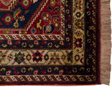 Full pile corner of a vintage Shiraz rug with intricate floral and boteh borders.