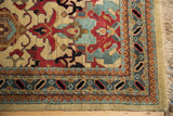Vintage Agra carpet corner with cherry red palmettes, dusty blue borders, and fringe.