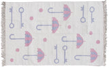 Close-up of playful pictorial Indian kilim rug, pink umbrellas, blue keys, polka dots, and ivory fringe.