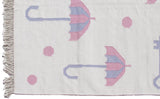 Ivory Indian Kilim rug with fringe, playful pink polka dots and striped umbrellas.