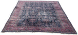 A full perspective view of the vintage Sarouk carpet, highlighting its deep indigo color and unidirectional floral design.