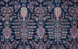 Collector Sarouk's hand-knotted Mille Fleur pattern with blush and ivory details on an indigo field.