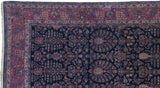 Corner of a fine Persian Sarouk showing its detailed cochineal red border and indigo Tree of Life field.