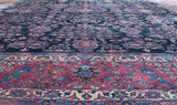 The potted vase and Tree of Life motif on the indigo field of a fine Persian Sarouk carpet.
