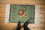 Corner view of vintage Armenian rug showing white fringe and thin banded navy, terracotta border.