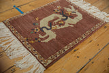 Pictorial Armenian dragon design and meandering border on the abrashed aubergine field.