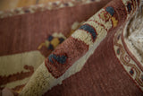 Plush, full pile of the pictorial Armenian dragon rug, highlighting aubergine and ivory motifs.